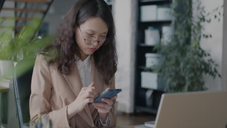 businesswoman working on mobile phone in office