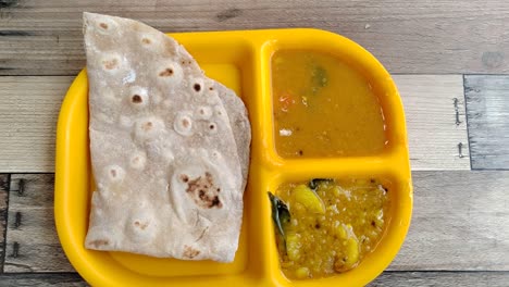 capati, served with two delicious gravies, makes for a perfect breakfast. this traditional flatbread offers a satisfying and flavorful start to your day.