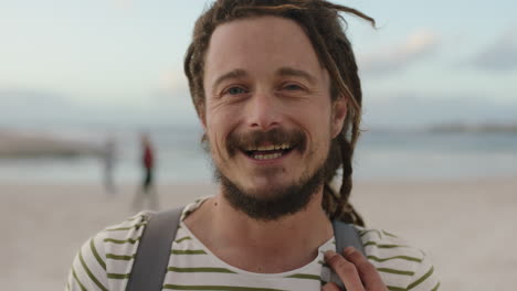 close up of happy man with dreadlocks portrait of optimistic man on beach smiling