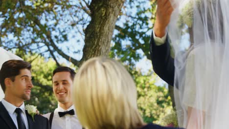 Groom-happily-looking-at-bride-and-her-father-4K-4k