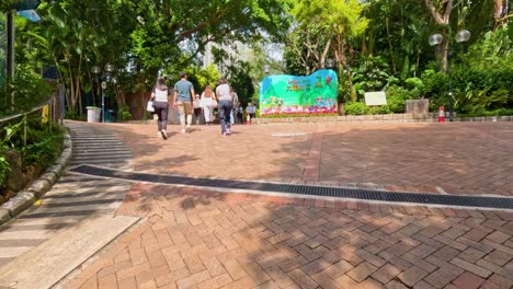 people walking through a vibrant public park