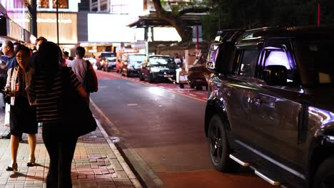 people walking along a busy city street