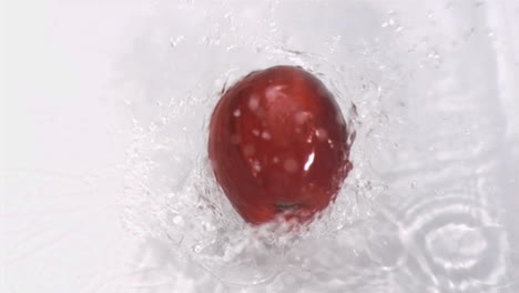 apple falling into water in super slow motion