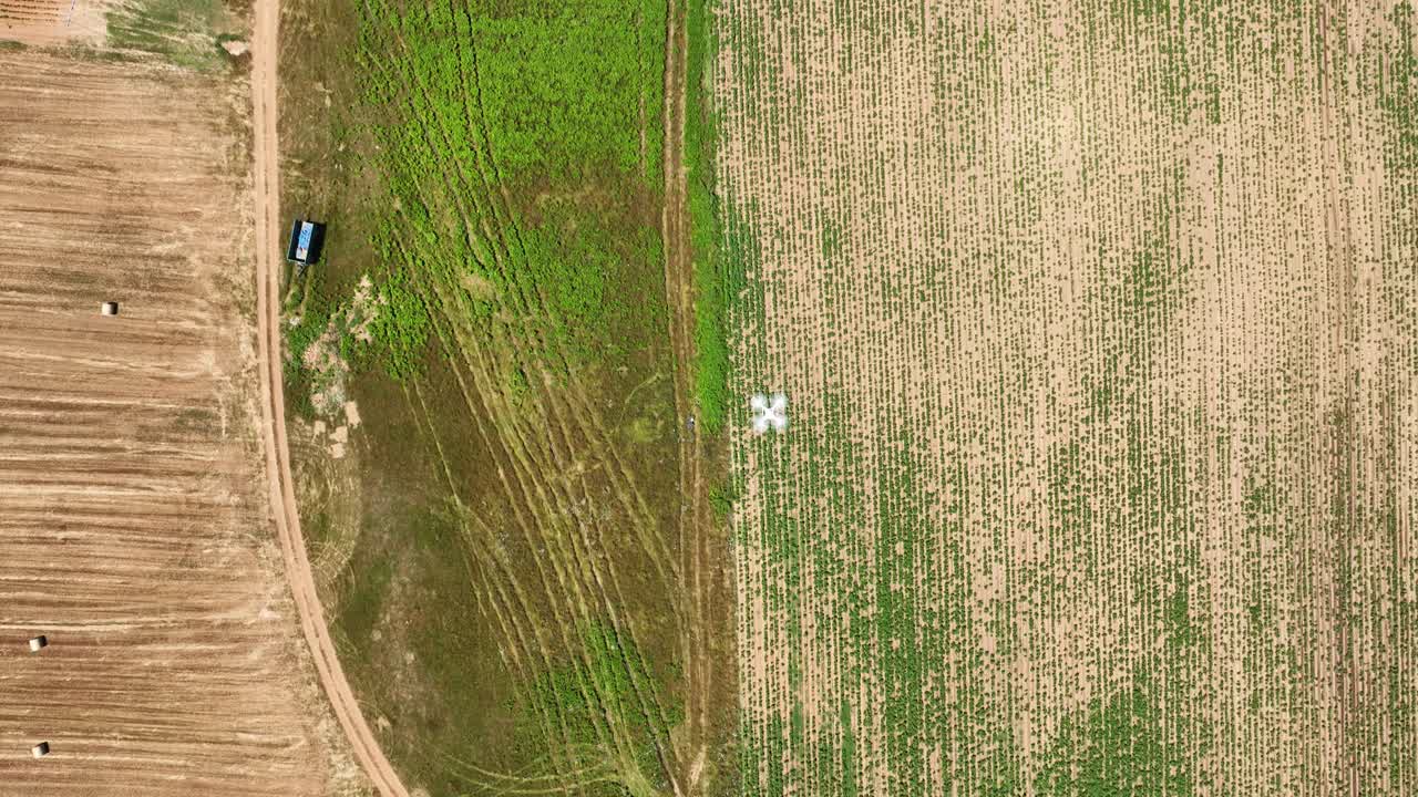 Aerial top down drone camera flying above agricultural fields, recording equipment