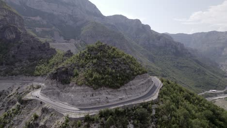 video de drones de un avión de descripción vacío sobre el paso de montaña "rrapsh serpentine" en la carretera sh20 en grabom albania, se puede ver pasar una motocicleta y un automóvil