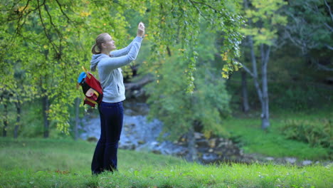 woman taking pictures of nature scenes