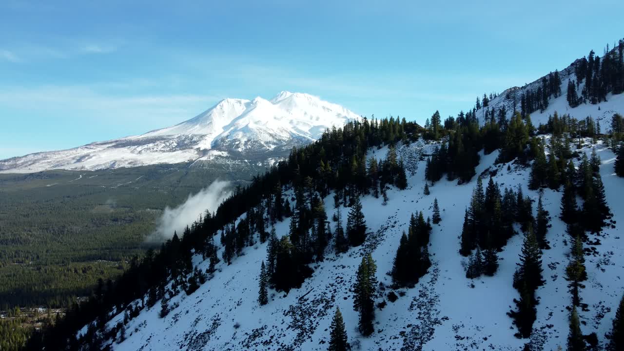 USA, CA, Weed, , 2024-12-27 - Drone view of Mt Shasta in winter with Black Butte in the foreground