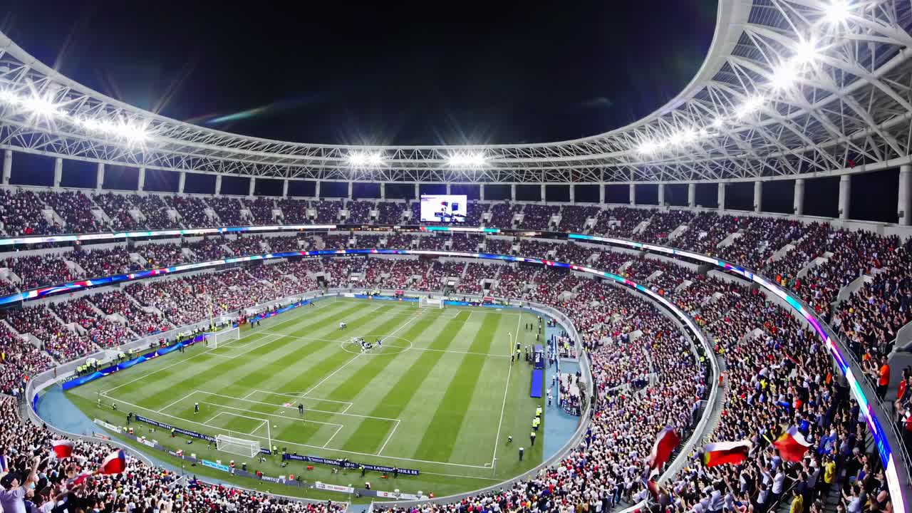Wide-angle video shot of a vibrant, packed stadium during a soccer match, capturing the energetic