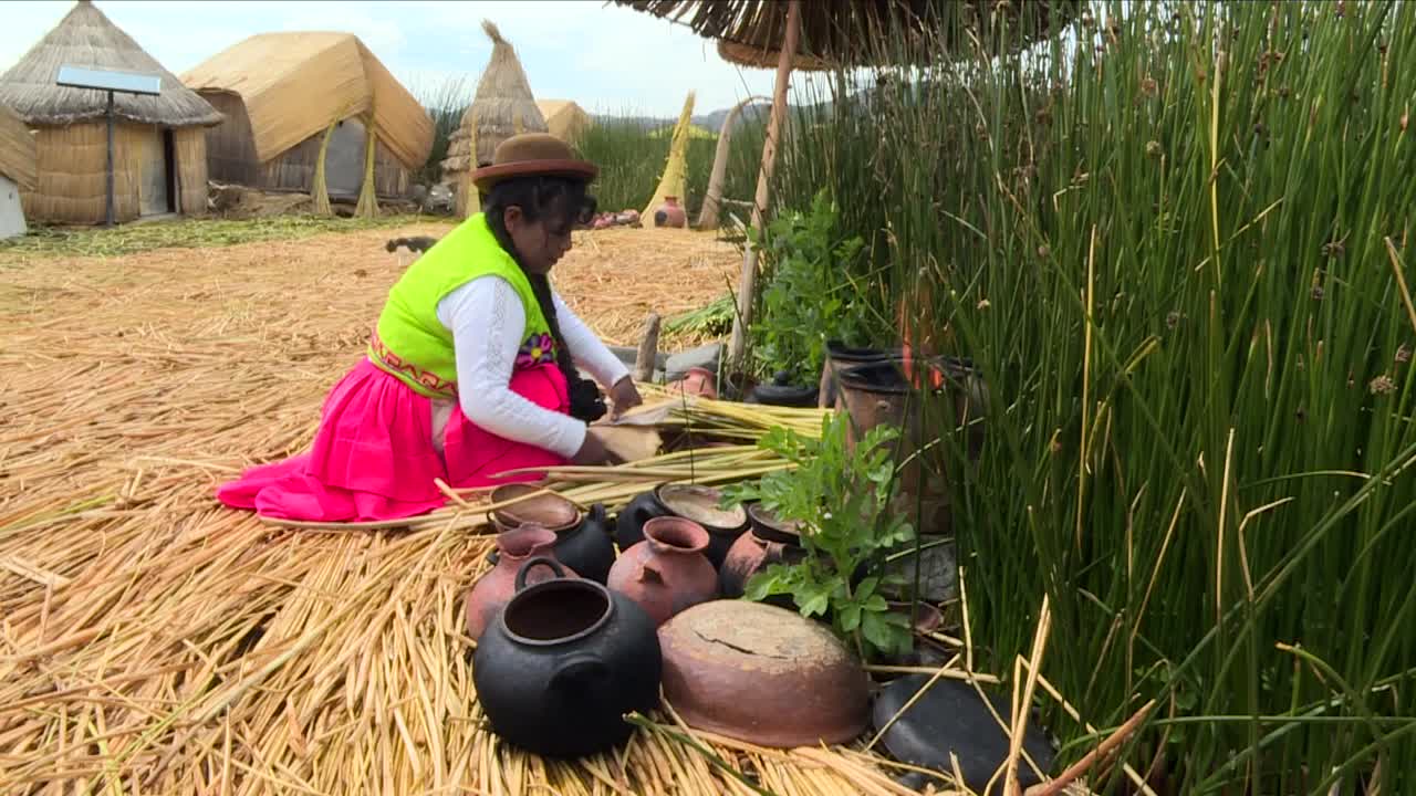 Peruvian indigenous of the Floating Islands Uros cooking with a traditional hoven