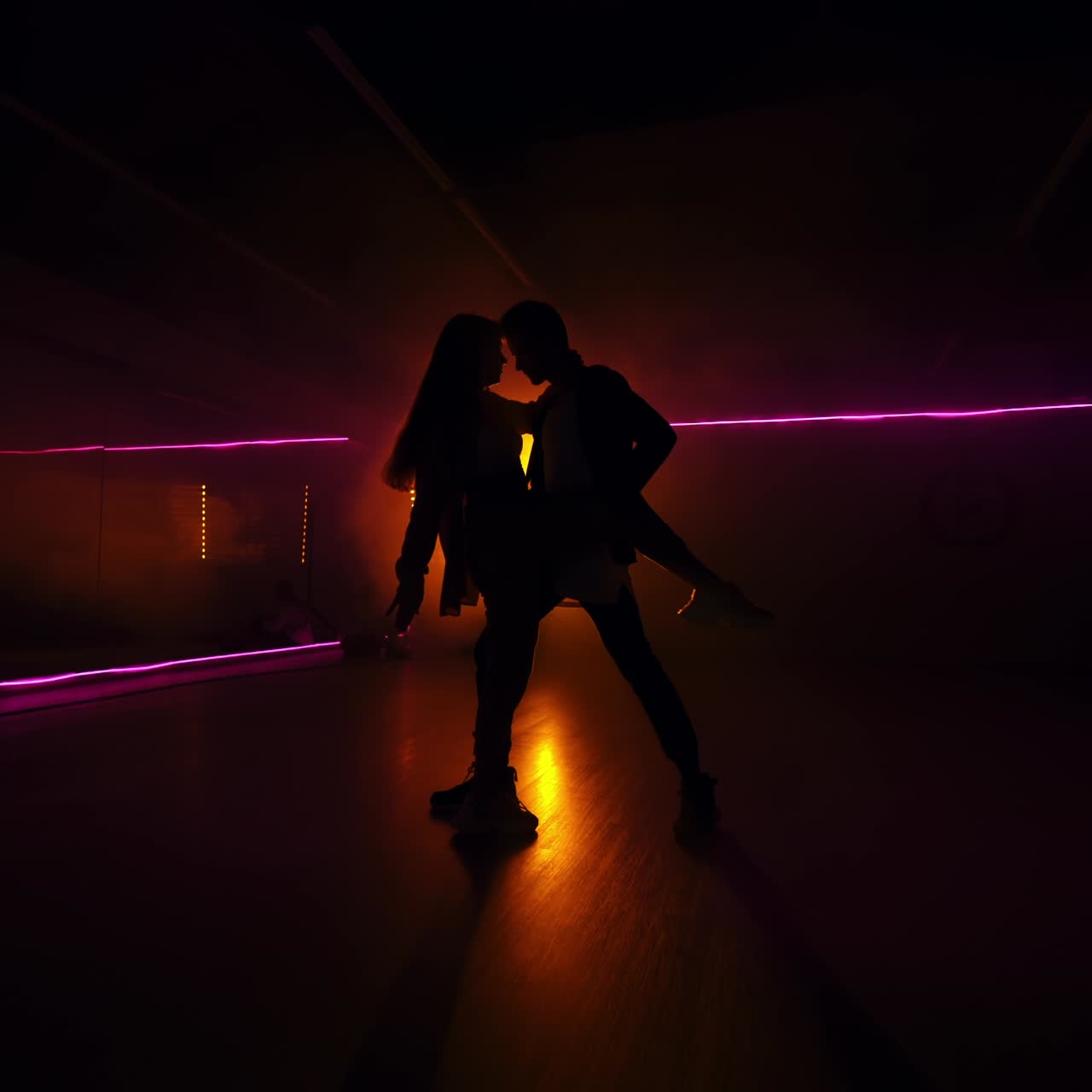 Dancing modern couple silhouette. Freestyle hip hop dancers