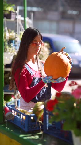 woman selling pumpkins at an outdoor market