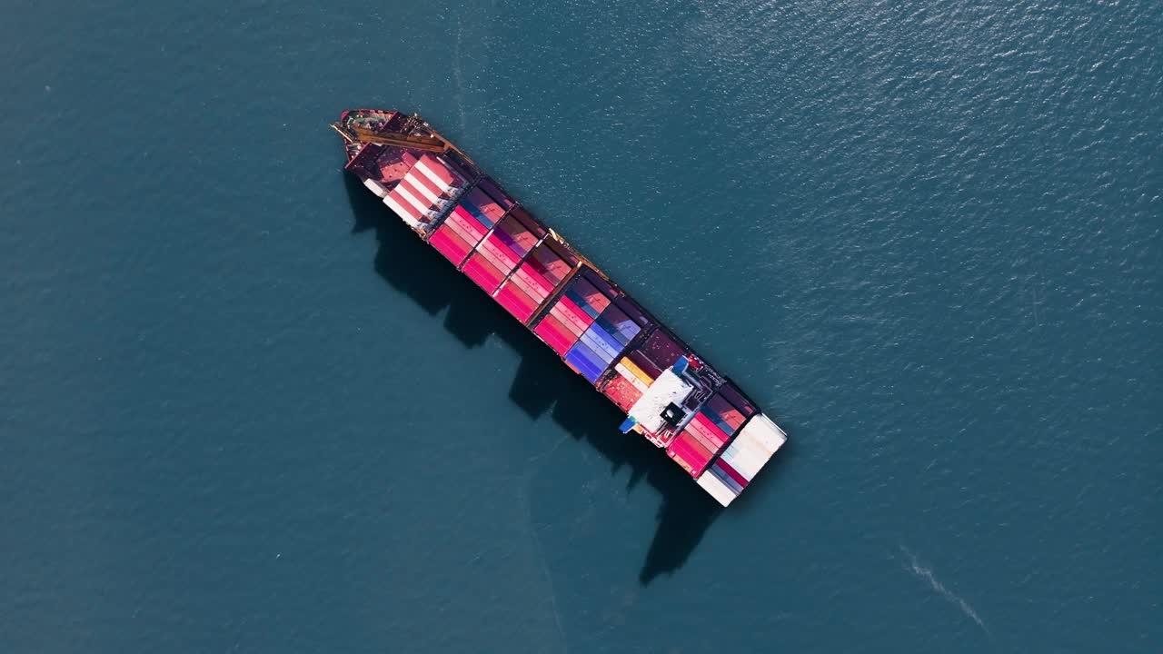 Container ship navigating through calm waters with colorful shipping containers on board during global trade operations