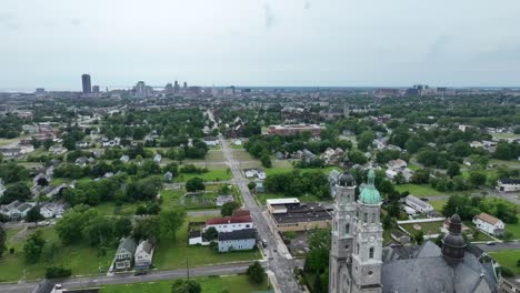 An-aerial-view-of-the-green-city-of-Buffalo,-New-York-with-storm-clouds-in-the-distance