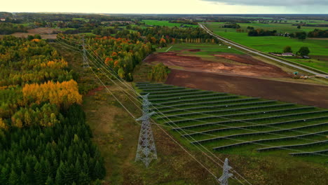 power electricity grid high voltage cable, field multicolor forest autumn fall