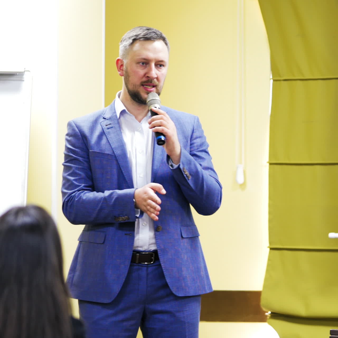 Businessman speaking at a podium in a conference or seminar