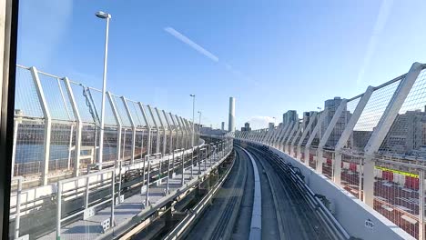 a monorail glides through tokyo, showcasing urban architecture under bright daylight. the camera captures smooth motion and vibrant cityscapes