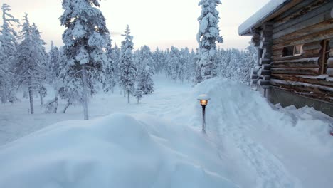 snowy winter wonderland landscape, with cabin, and landscape lights in lapland, finland, arctic circle