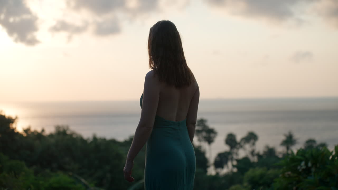 Woman admiring the ocean view at sunset