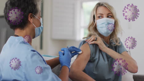 animation of virus cells over biracial female doctor with patient taking vaccine