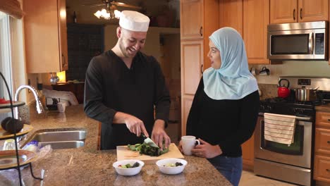 middle eastern young couple make salad he chops track right