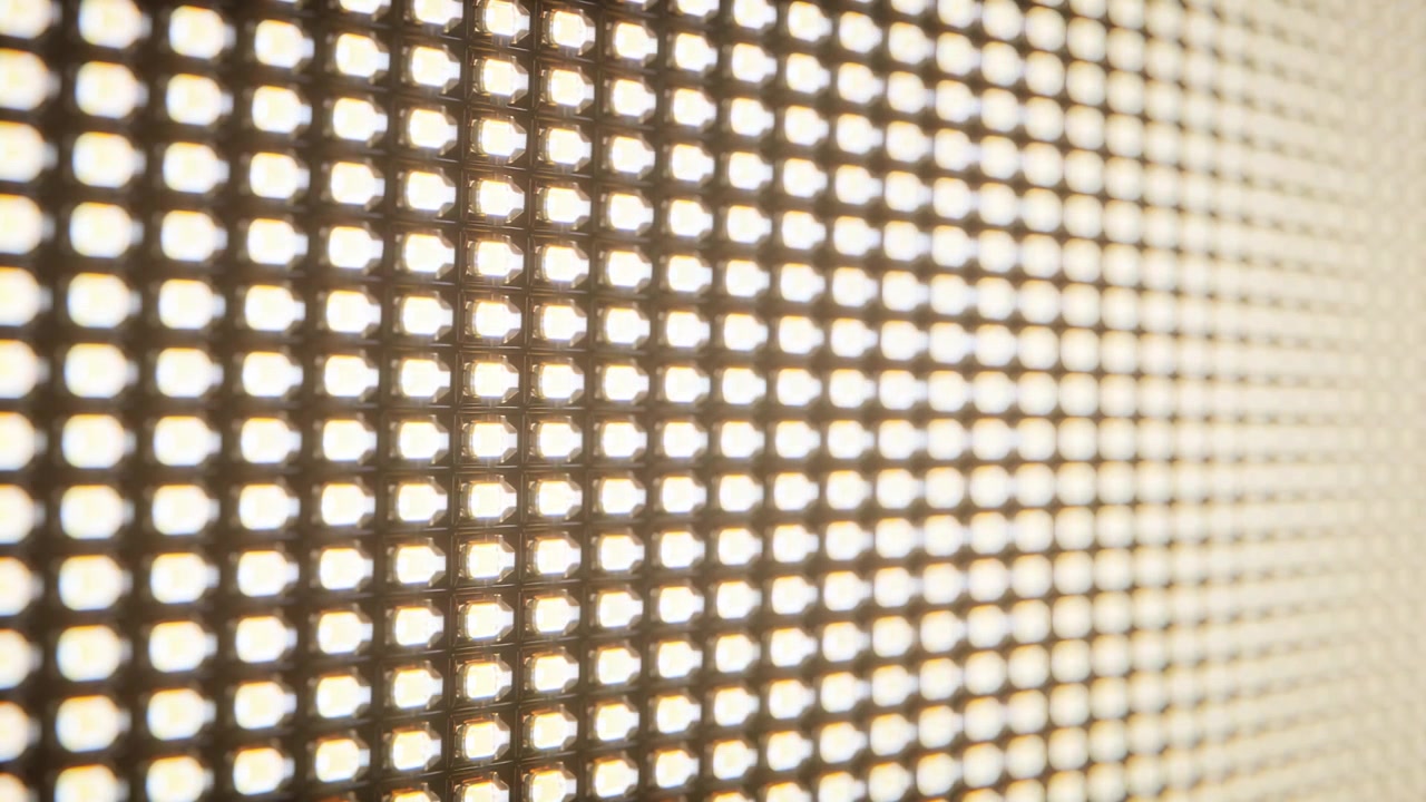 Shifting lens sliding right, changing focus on perforated grid at window, revealing pink backlight