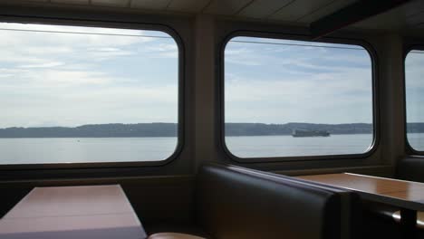 walking shot of empty booths in a washington state ferry on a sunny day