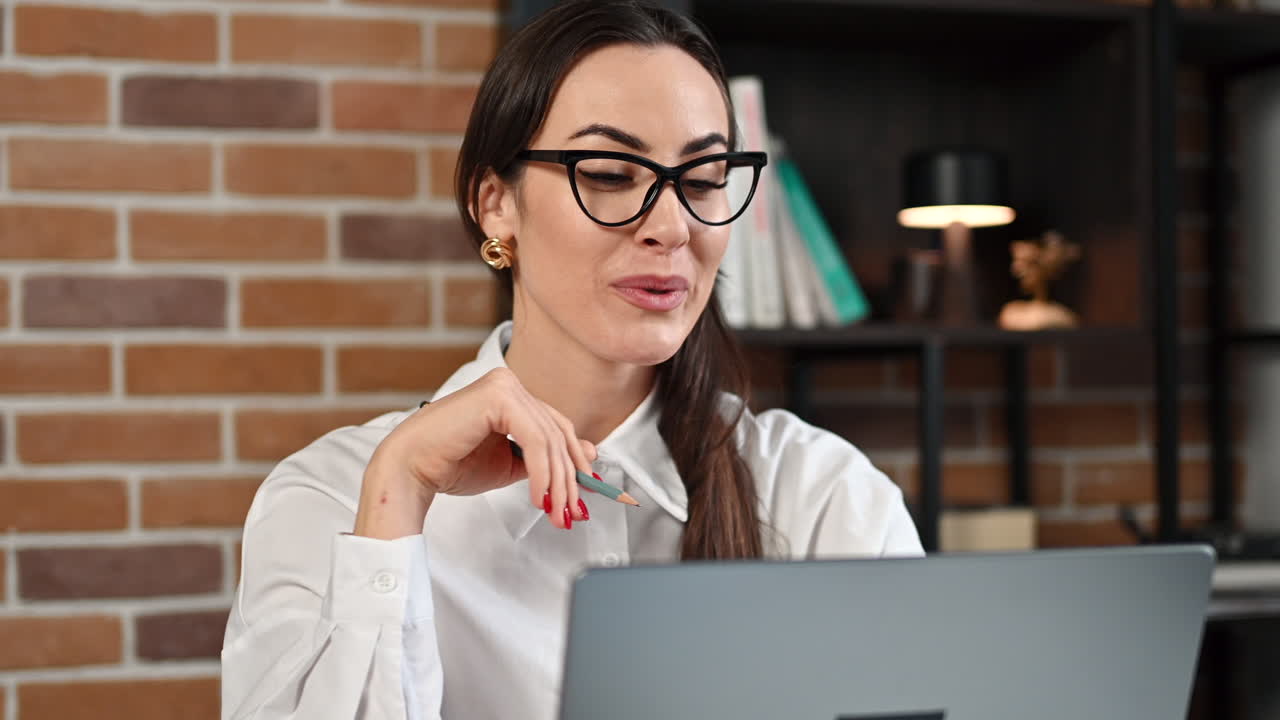 Woman talking on a web conference at an office