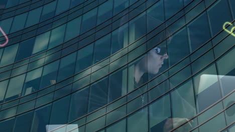 multiple changing numbers and alphabets over male hacker using laptop against tall building