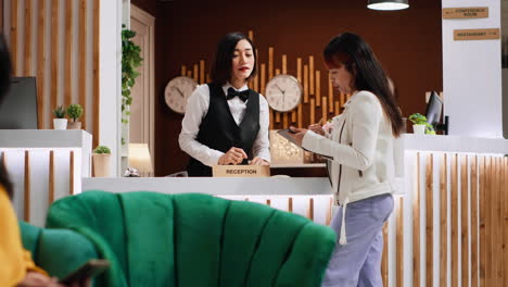 customer signs check in documents on tablet at reception