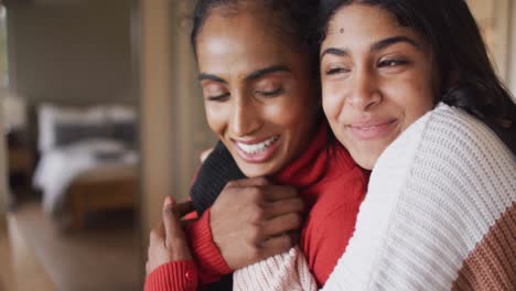Video-of-happy-biracial-female-friends-embracing
