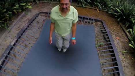 Senior-man-jumping-on-trampoline-4k