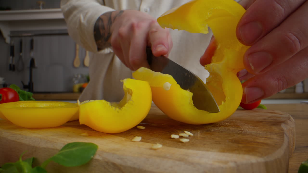 Chef cutting yellow bell peppers
