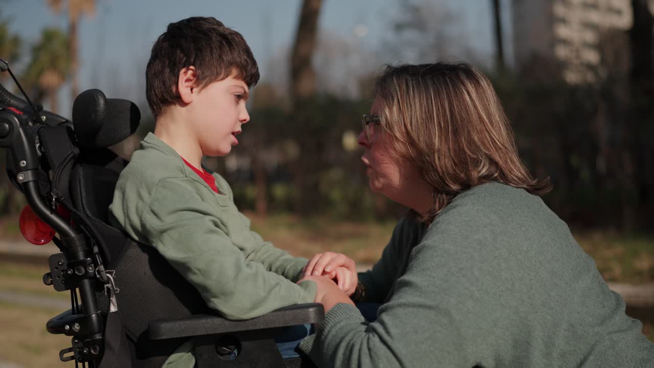 Mother and Child in Wheelchair Sharing a Moment