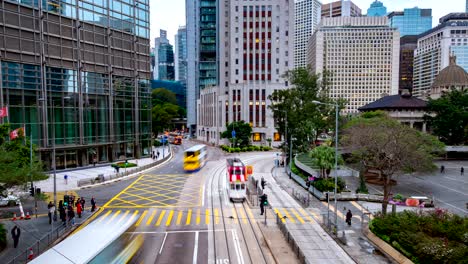 4k time lapse of hong kong street at day time. moving car pass thru the city