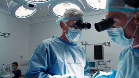 surgeon using a microscope during a medical procedure in an operating room