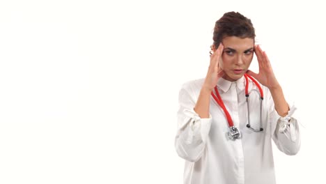 Stressed-surgeon.-Depressed-young-doctor-touching-her-head-with-hands-and-keeping-eyes-closed-while-walking-isolated-on-white-background