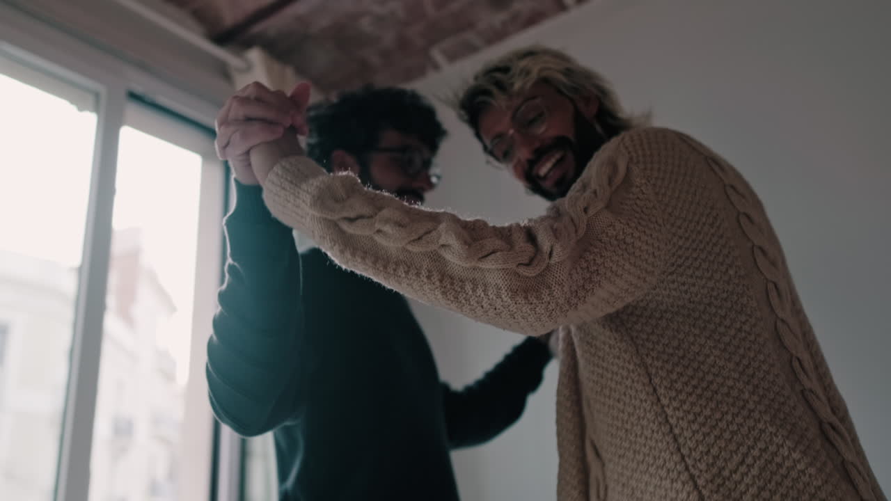 Gay Couple Dancing at Home Together