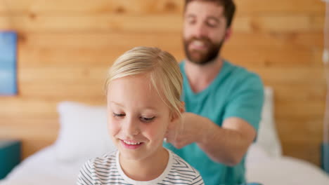 girl, dad helping with braid