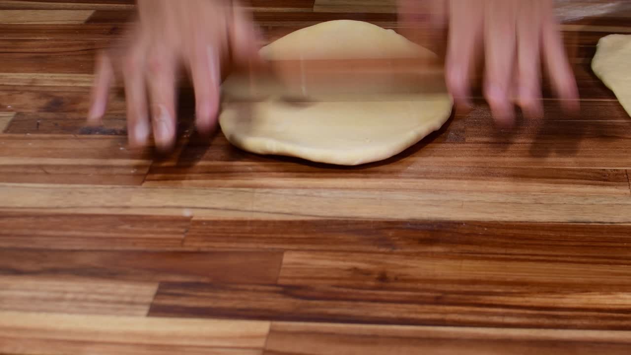 Close-up of authentic artisanal dough preparation, capturing the rhythmic movement and tactile texture of traditional baking
