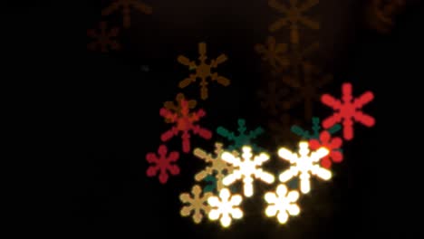Beautiful-snowflake-bokeh-from-moving-car-and-traffic-lights-at-the-evening,-Christmas,-winter-or-holiday-background-concept,-copyspace