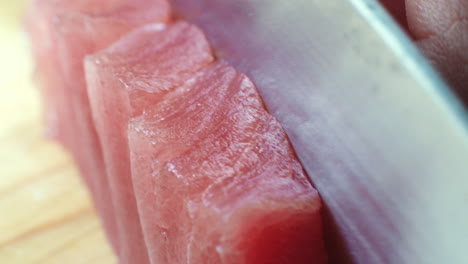 Close-up-of-Raw-Tuna-Being-Sliced-into-Pieces-for-Sushi-and-Sashimi