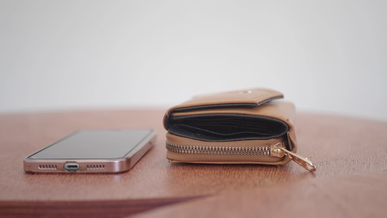 Brown Wallet and Phone on Table