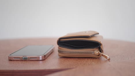 brown wallet and phone on table