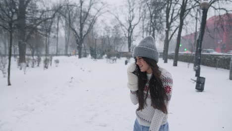 woman enjoying a snowy day in the park