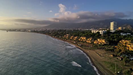 Aerial-view-of-urban-coastline-moving-backwards