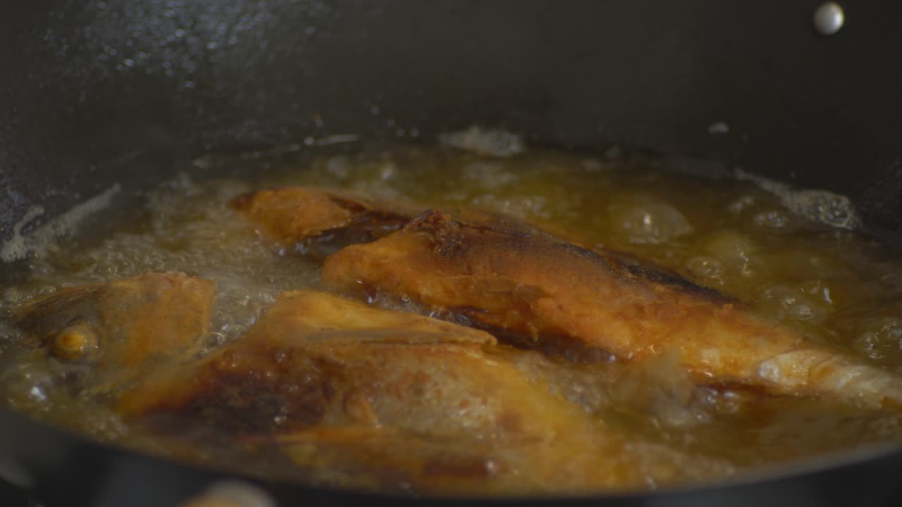 deep frying fish in sizzling oil