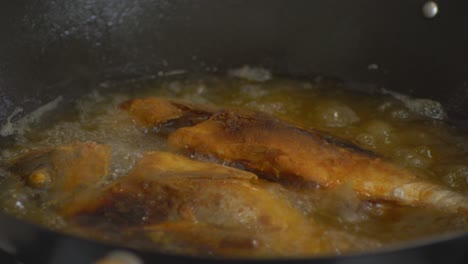 deep frying fish in sizzling oil