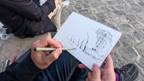 artist sketching a riverside scene in paris