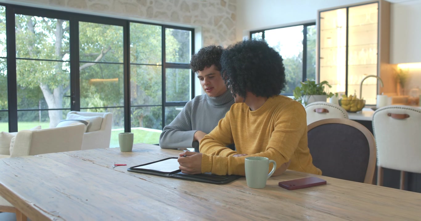 African American men reacting to tablet, leaning in, pointing, tapping while reviewing content
