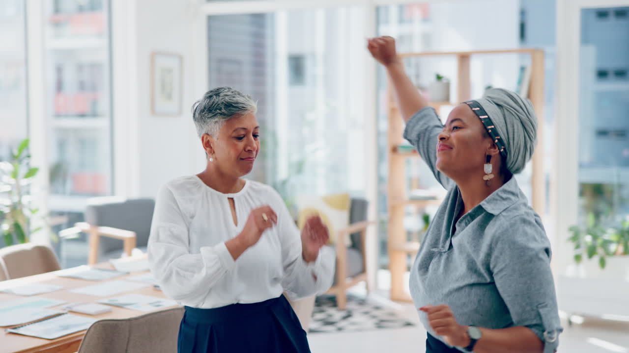 Business women, dancing and celebration in office
